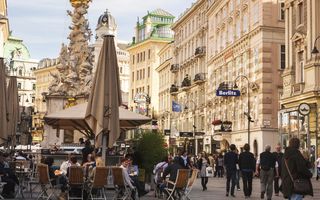 Vienna, Austria - September 28, 2014: Tourists walk alongside the Graben street of Vienna and people are eating outside. The  street is overcrowded with